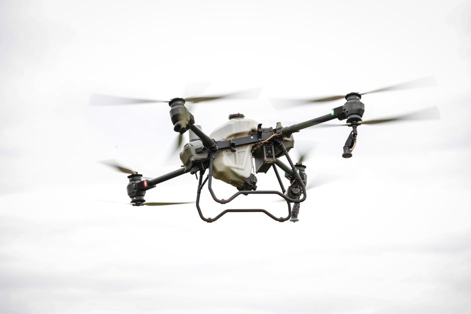 Aerial view of a drone surveying a landscape, showcasing advanced technology and precision in aerial mapping.